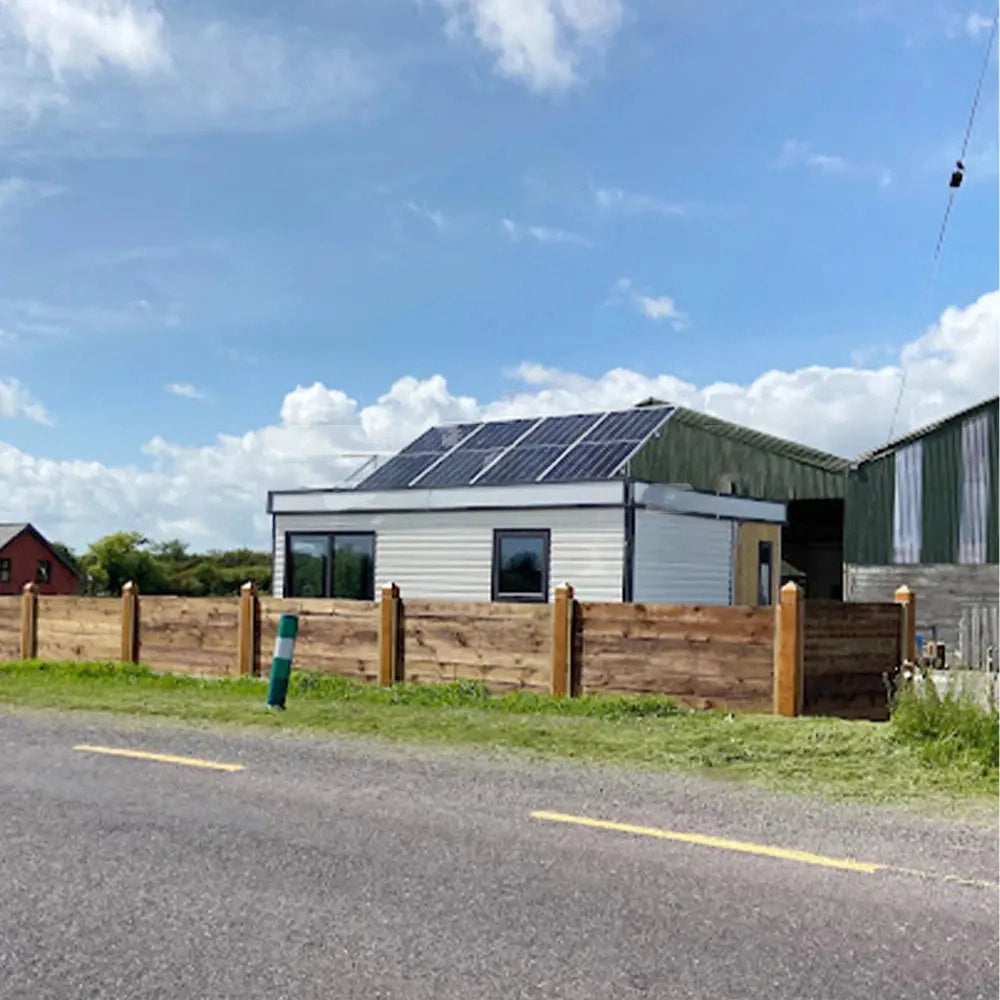 Expandable prefab home deployed on site with modern exterior finish